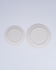 Tashkeel ceramic bisque plate with smooth, unglazed finish and round shape, showcasing a handcrafted, matte surface.